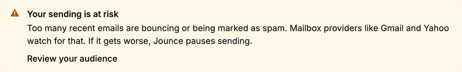 The amber banner at the top of the Emails page, reading Your sending is at risk.
